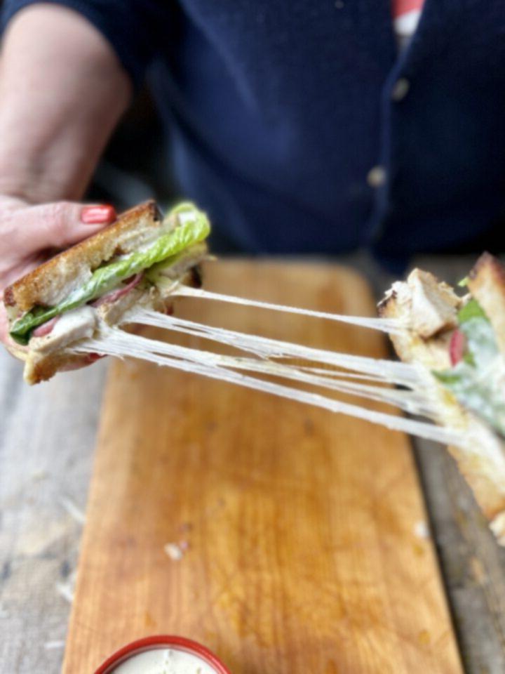 Cheese pull from sandwich.